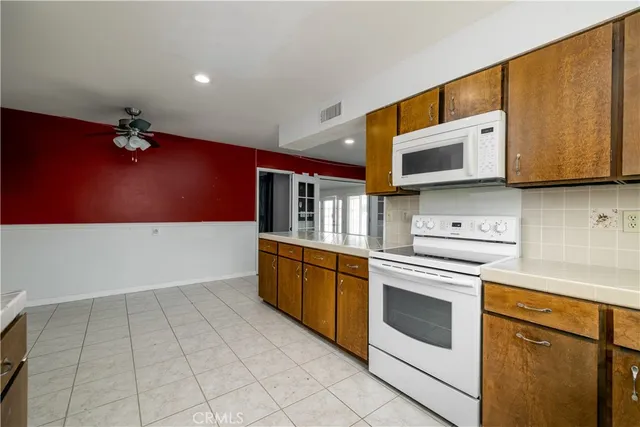 a kitchen with stainless steel appliances granite countertop a stove a microwave and a sink