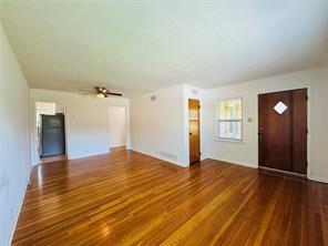 1015 West Sycamore Street Sherman, TX 75092 - Photo 13 of 35 a view of empty room with window and wooden floor