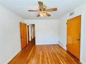 1015 West Sycamore Street Sherman, TX 75092 - Photo 34 of 35 a view of a room with wooden floor and a ceiling fan