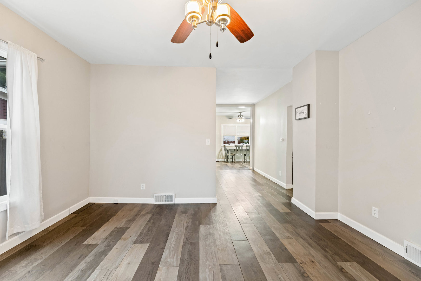 809 Poplar Street Ottawa, IL 61350 - Photo 4 of 22 a view of a room with wooden floor white walls and a window