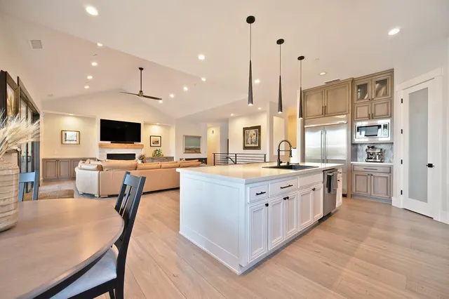 a spacious bathroom with a double vanity sink mirror and bathtub