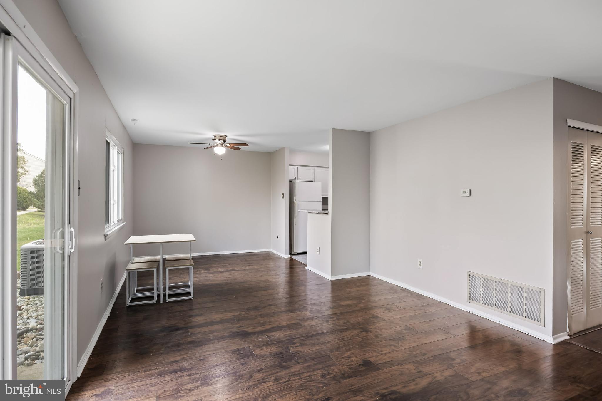 45 Sandra Road Voorhees, NJ 08043 - Photo 4 of 28 an empty room with wooden floor and windows