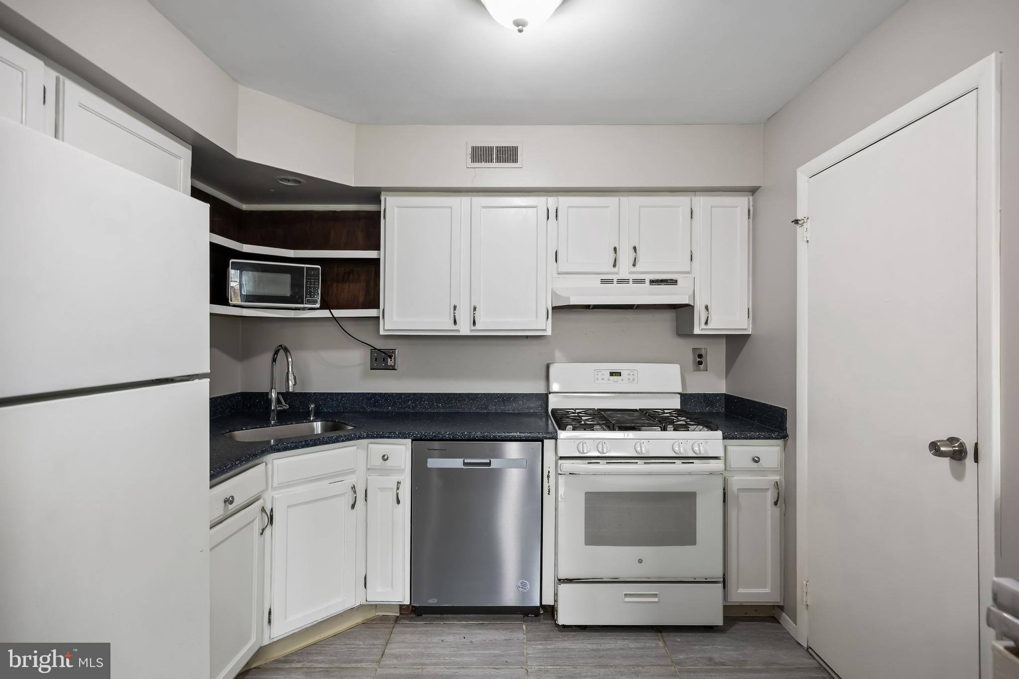 45 Sandra Road Voorhees, NJ 08043 - Photo 8 of 28 a kitchen with white cabinets and white appliances