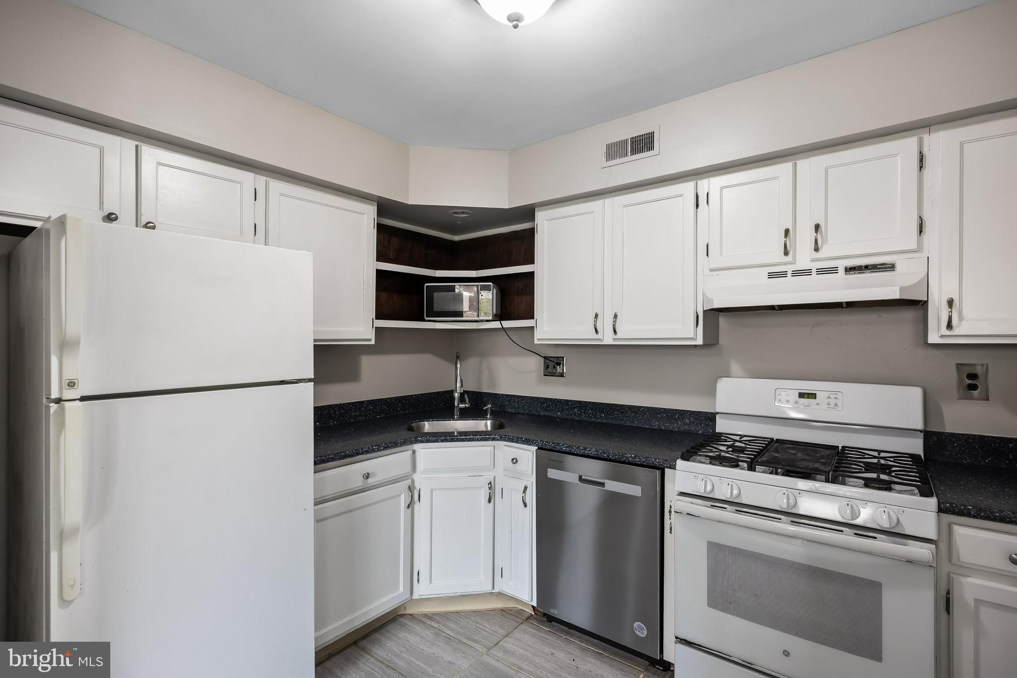 45 Sandra Road Voorhees, NJ 08043 - Photo 9 of 28 a kitchen with white cabinets and white appliances