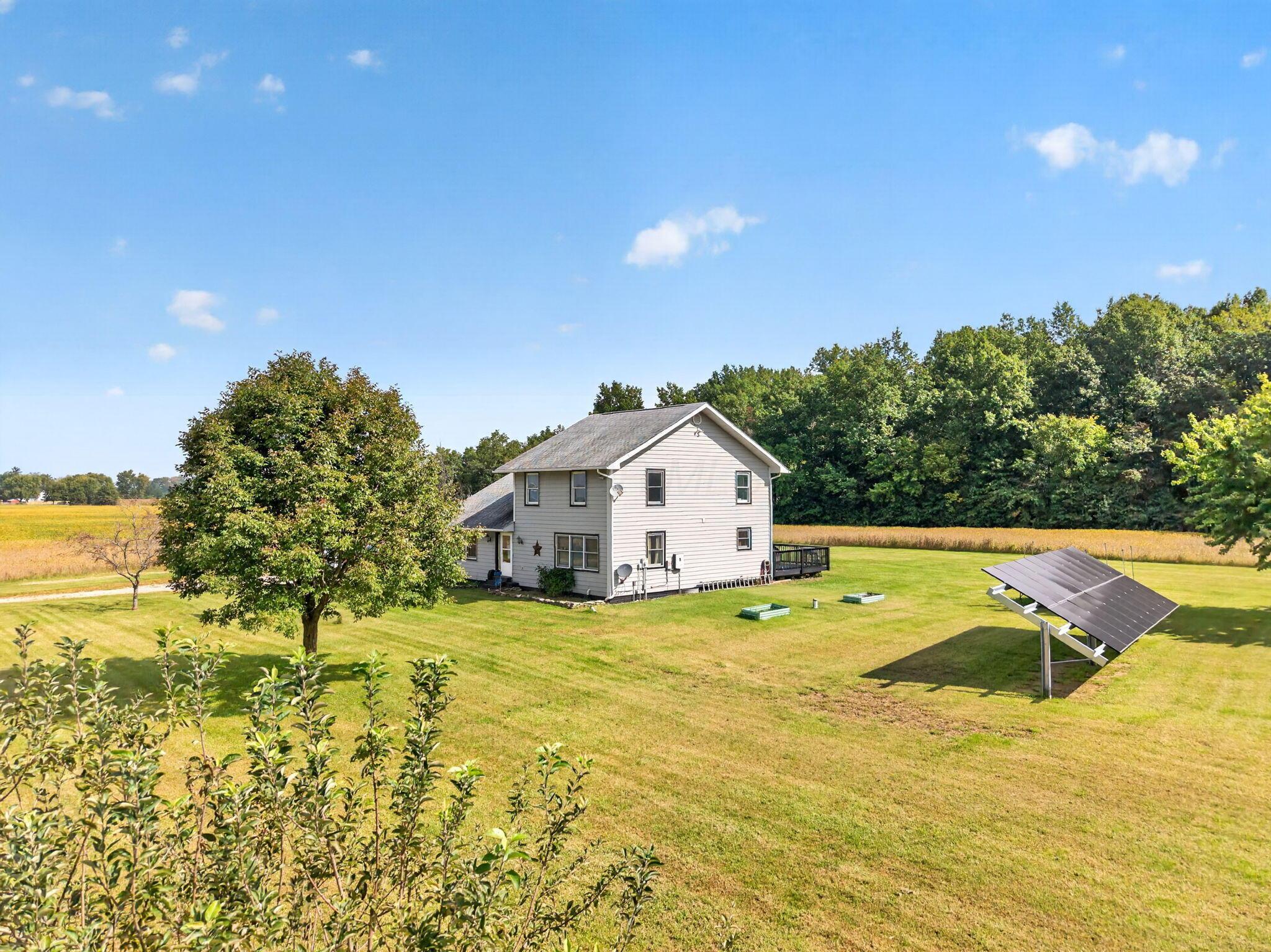 4780 North Section Line Road Radnor, OH 43066 - Photo 6 of 79 Expansive grassy grounds featuring mature trees and a ground-mounted solar array