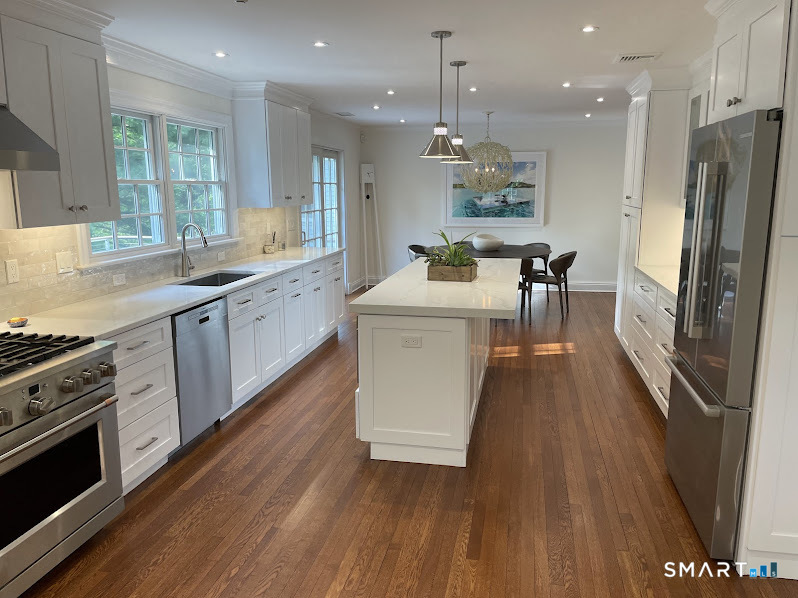 9 Tory Hole Road Darien, CT 06820 - Photo 8 of 33 a large kitchen with stainless steel appliances granite countertop a lot of counter space and wooden floor