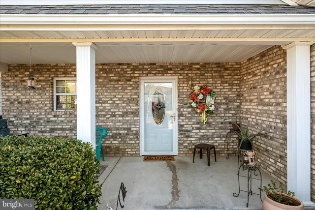 a front view of a house with outdoor seating