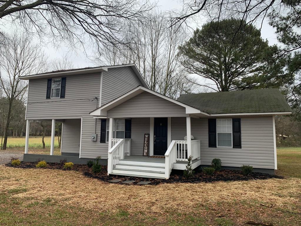 a front view of a house with a yard