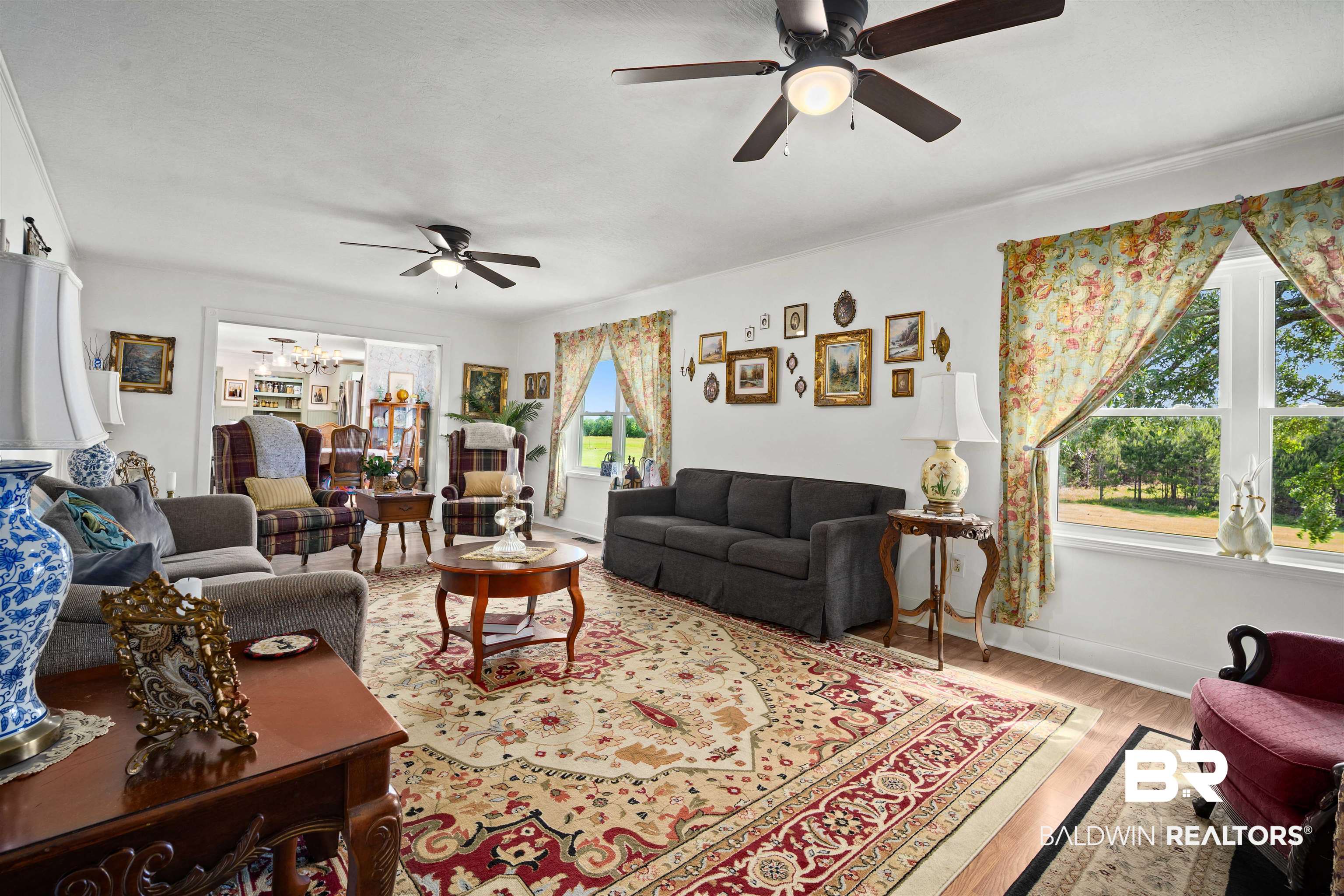 22 Horace Odom Road Millry, AL 36558 - Photo 6 of 39 Living room featuring light wood-style flooring, a ceiling fan, and a chandelier