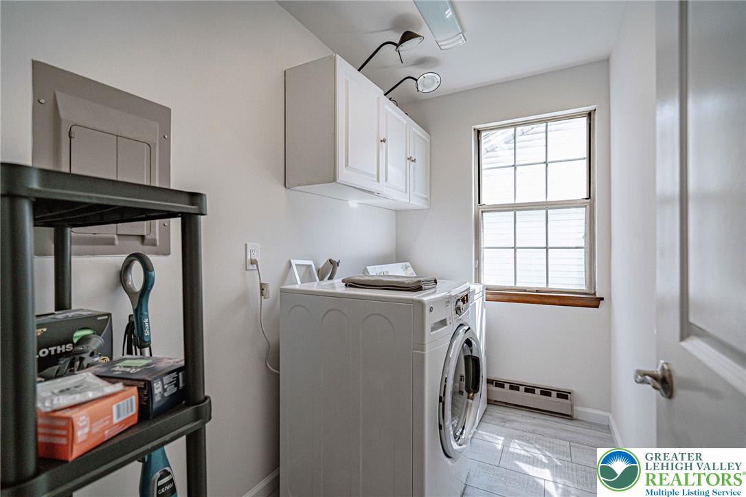 25 North 8th Street Emmaus, PA 18049 - Photo 14 of 51 Functional laundry room featuring a washer, dryer, and cabinetry for organized storage.