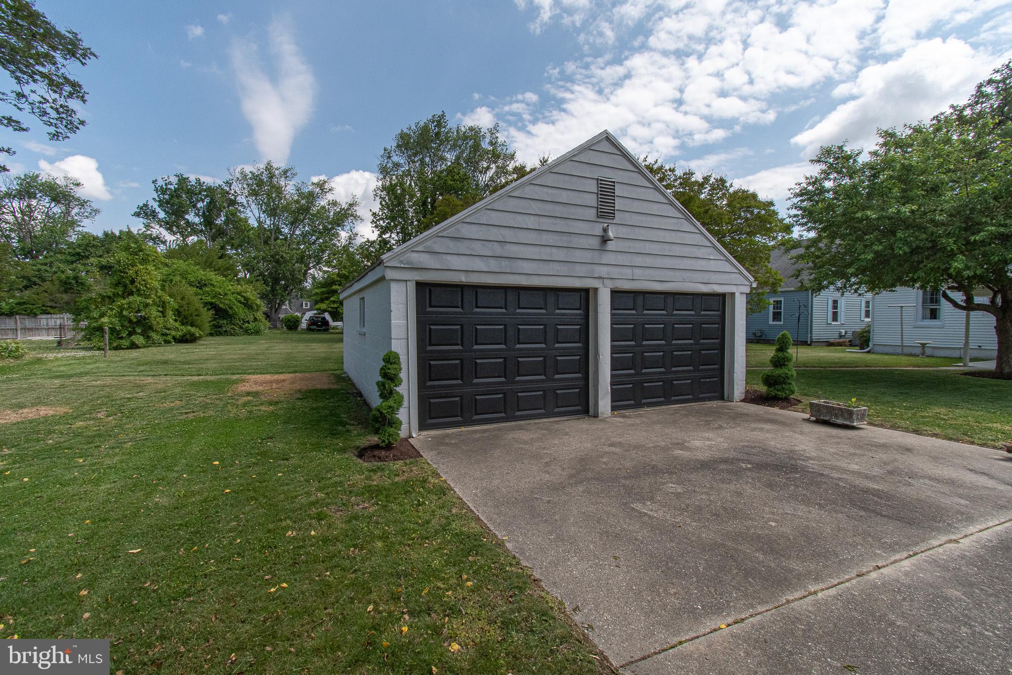 207 Crusader Road Cambridge, MD 21613 - Photo 72 of 76 a front view of a house with a yard and garage