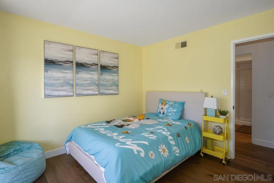 13053 Caminito Del Rocio Del Mar, CA 92014 - Photo 31 of 49 a bedroom with a bed and wooden floor