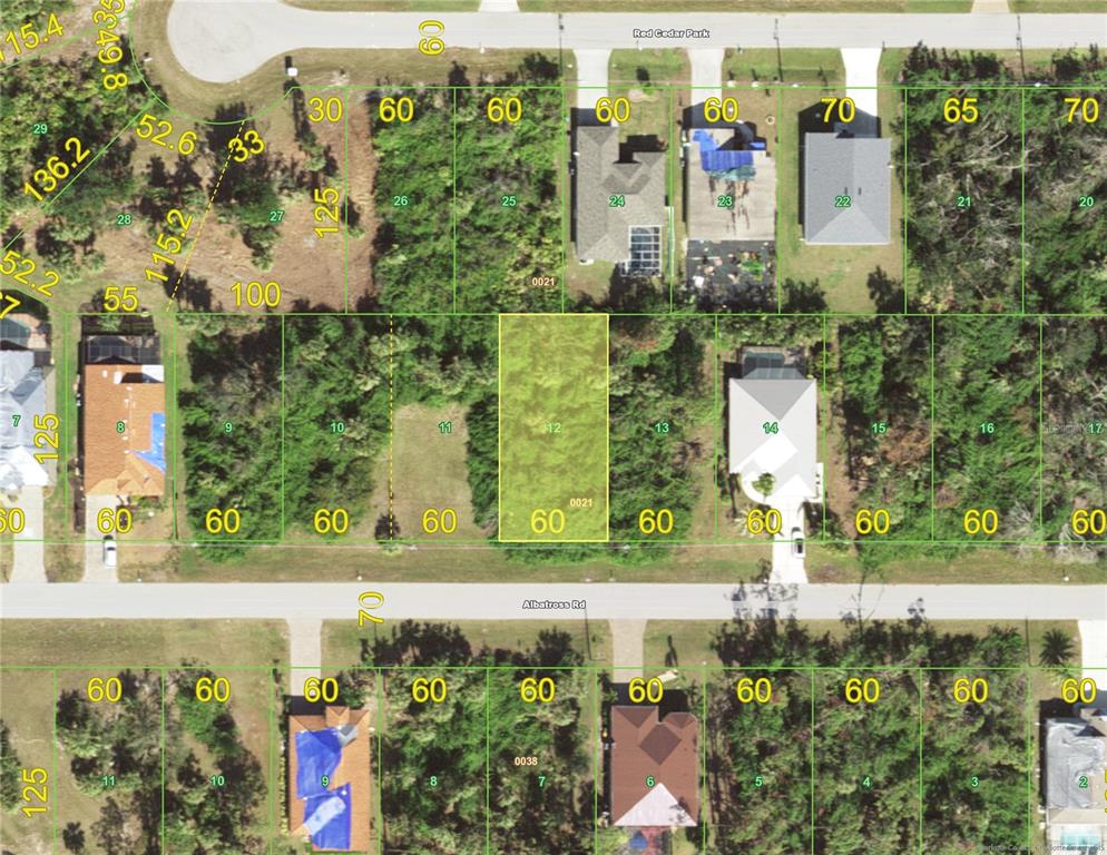 an aerial view of a residential building with a yard and outdoor seating