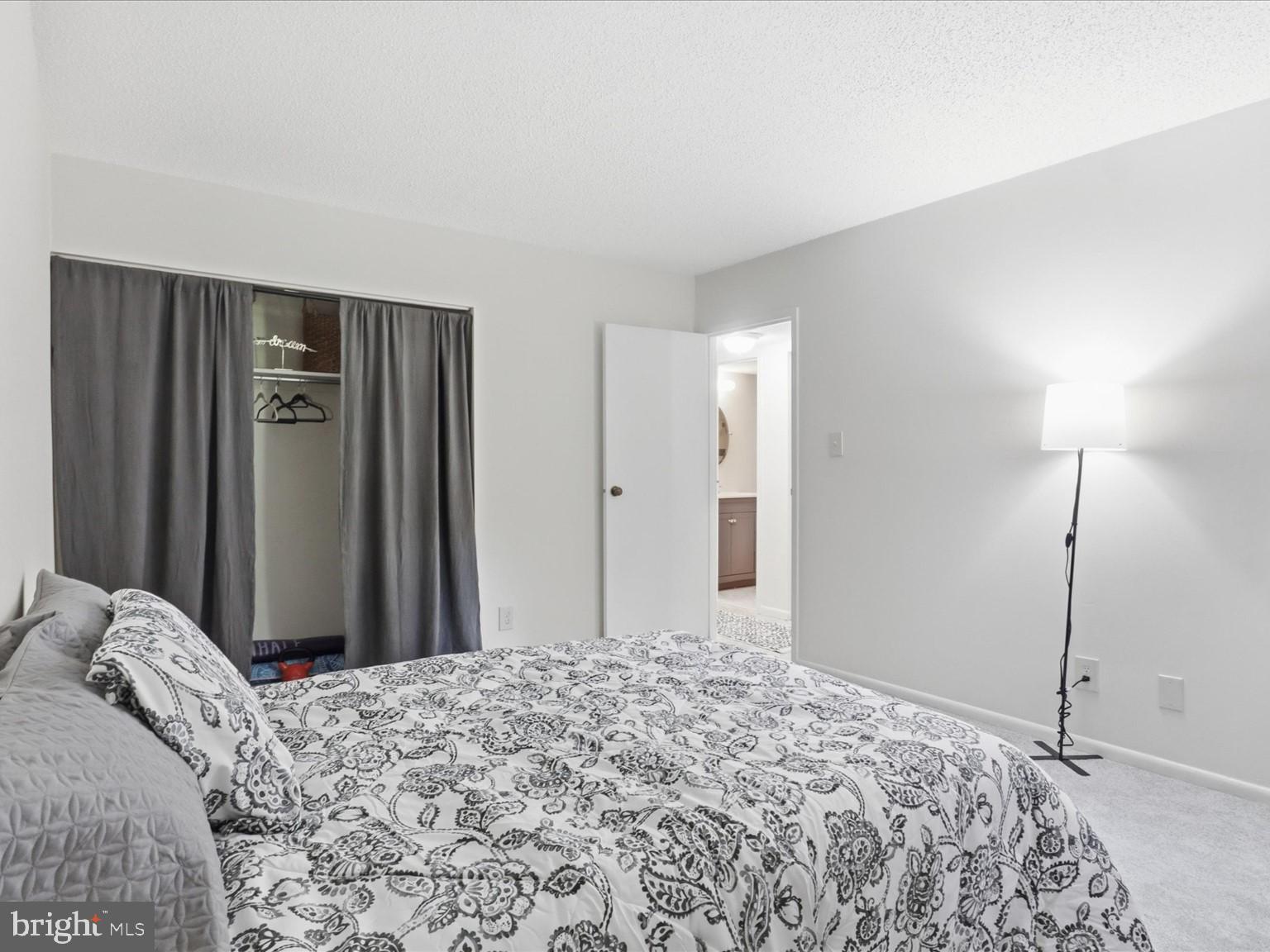 11809 Breton Court, Unit 2B Reston, VA 20191 - Photo 21 of 29 a bedroom with a bed and a mirror