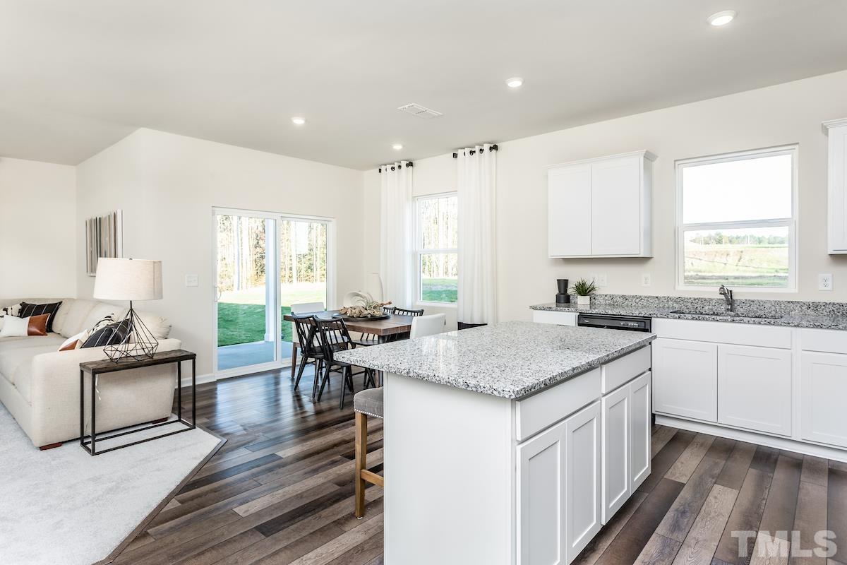 1644 Arapahoe Ridge Drive Raleigh, NC 27604 - Photo 6 of 10 a kitchen with stainless steel appliances granite countertop a stove a sink and a refrigerator