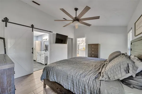 a bedroom with a bed and a flat screen tv