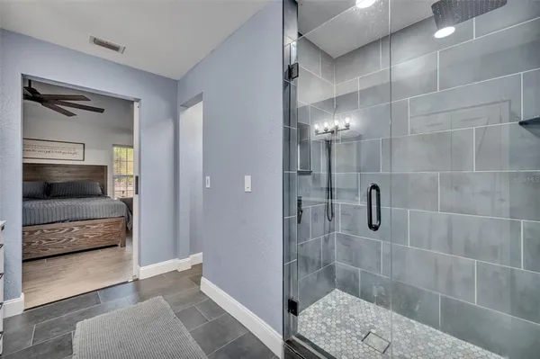 a bathroom with a shower and a sink