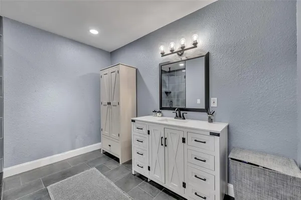 a bathroom with a double vanity sink and mirror