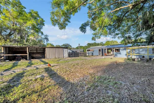 a view of a house with backyard and sitting area