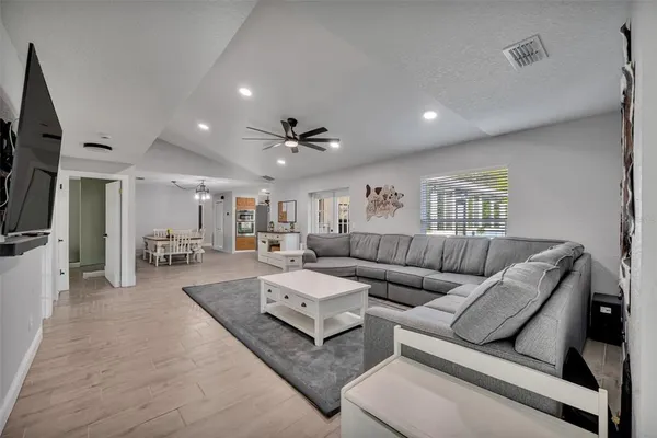 a living room with furniture and a wooden floor