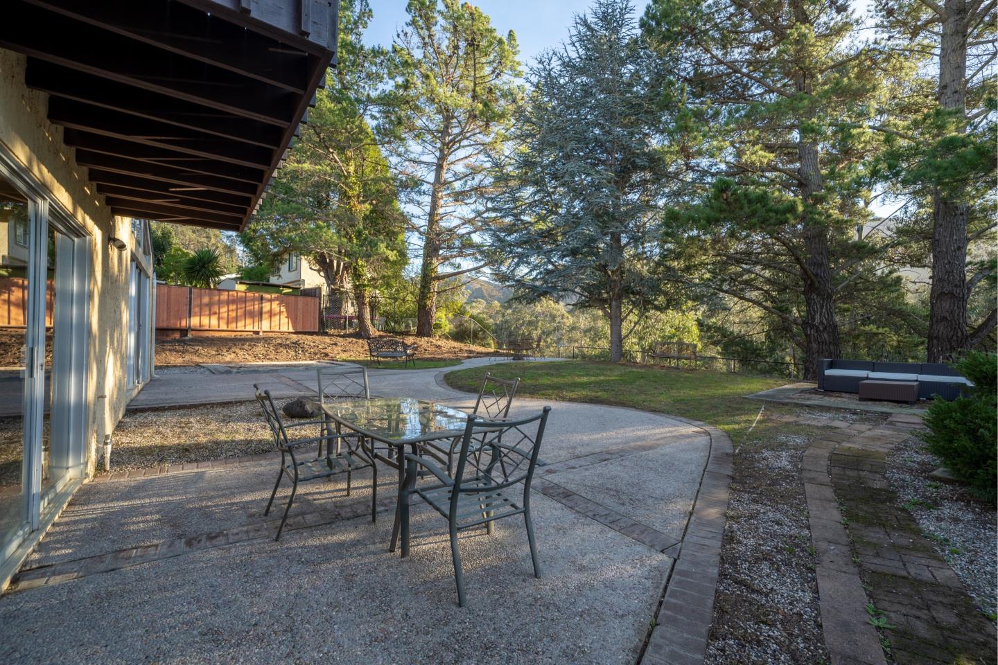935 Park Pacifica Avenue Pacifica, CA 94044 - Photo 13 of 44 a view of patio with chairs and table under an umbrella