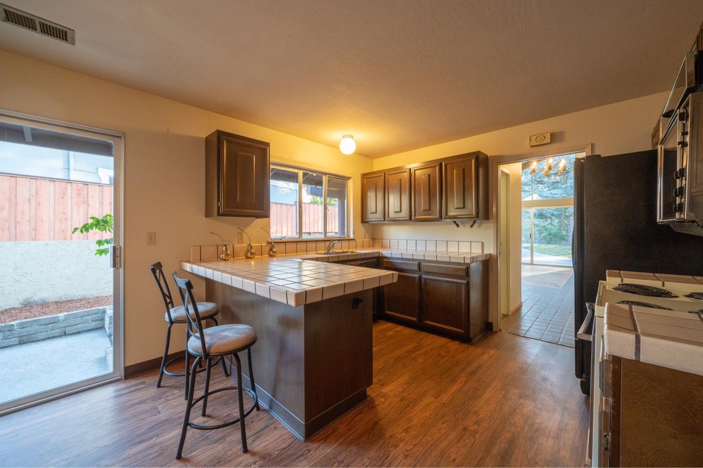 935 Park Pacifica Avenue Pacifica, CA 94044 - Photo 16 of 44 a kitchen with granite countertop a stove a sink dishwasher a refrigerator cabinets and wooden floor
