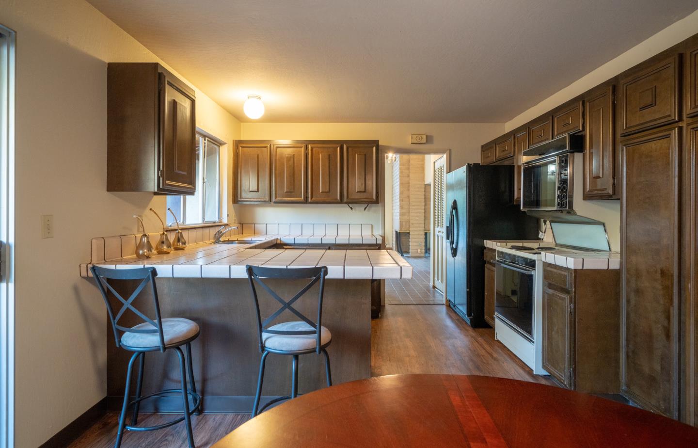 935 Park Pacifica Avenue Pacifica, CA 94044 - Photo 18 of 44 a kitchen with kitchen island a dining table chairs stainless steel appliances and cabinets