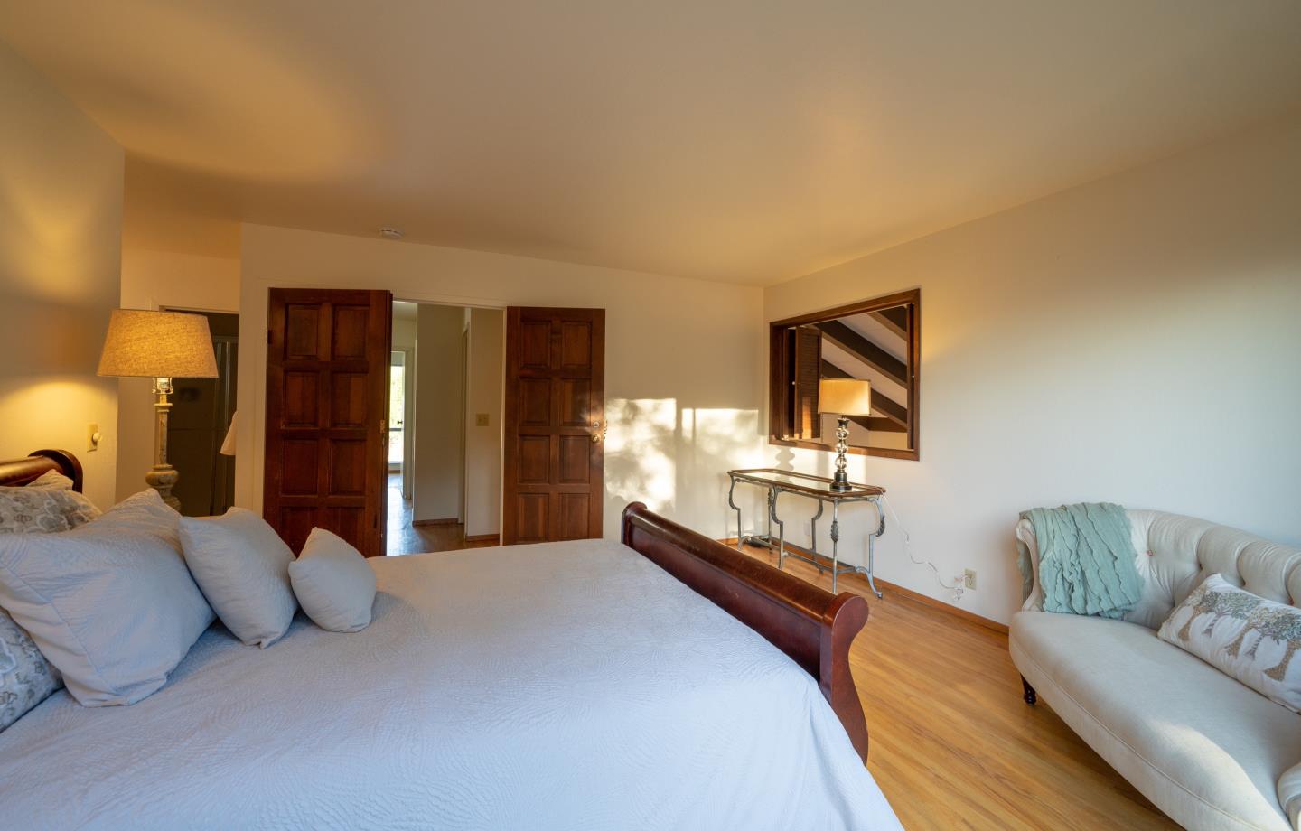 935 Park Pacifica Avenue Pacifica, CA 94044 - Photo 19 of 44 a bedroom with a large bed couch and dresser