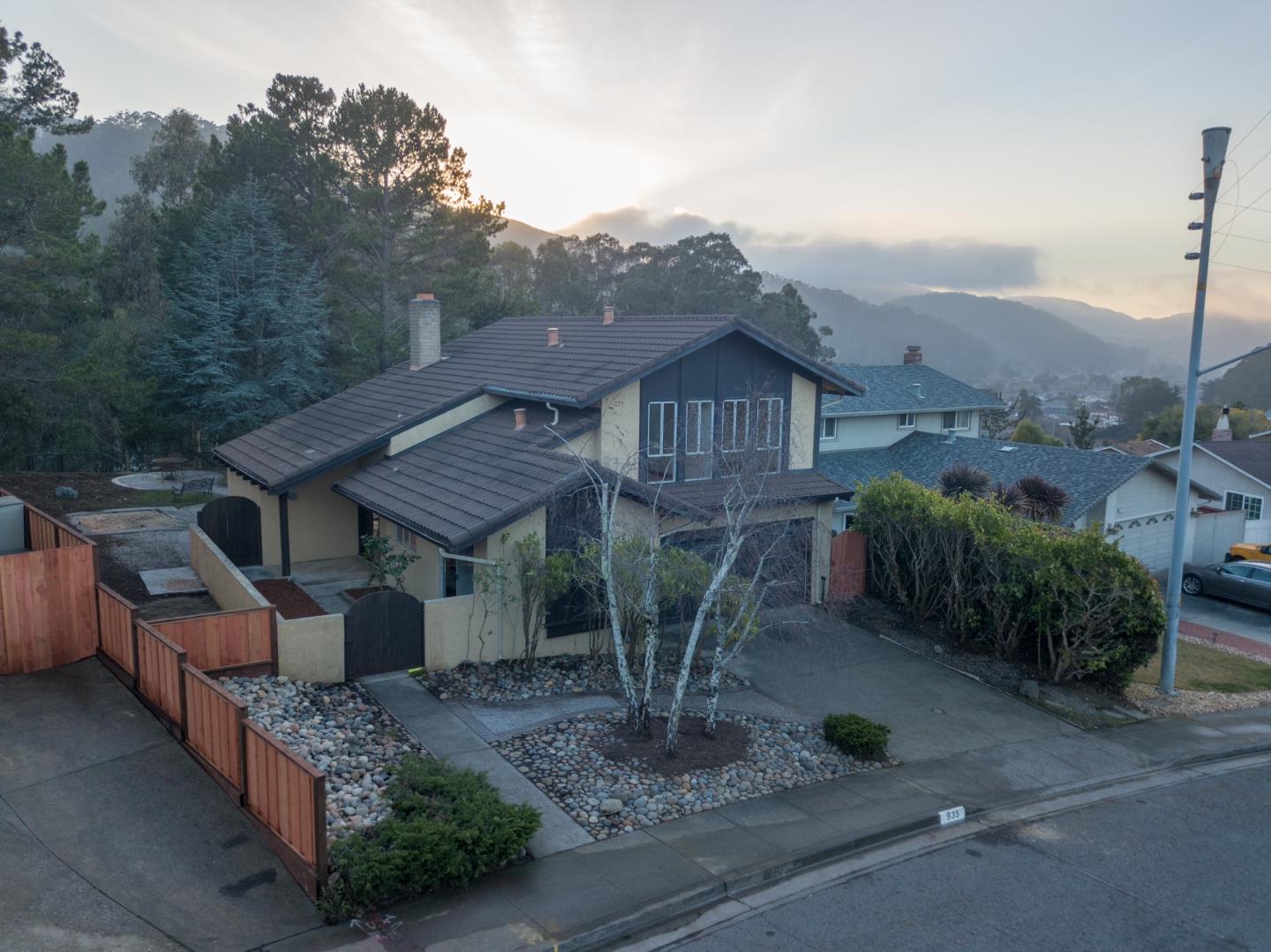 935 Park Pacifica Avenue Pacifica, CA 94044 - Photo 2 of 44 a view of a house with a yard and roof