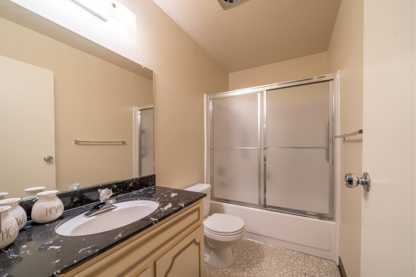 935 Park Pacifica Avenue Pacifica, CA 94044 - Photo 26 of 44 a bathroom with a granite countertop sink toilet and shower