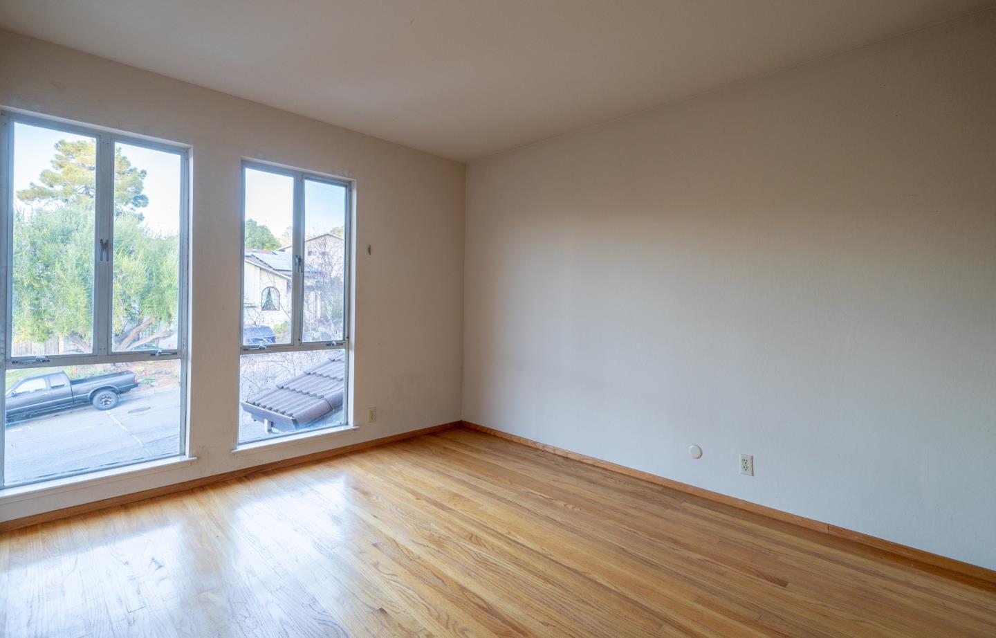 935 Park Pacifica Avenue Pacifica, CA 94044 - Photo 28 of 44 a view of an empty room with wooden floor and a window