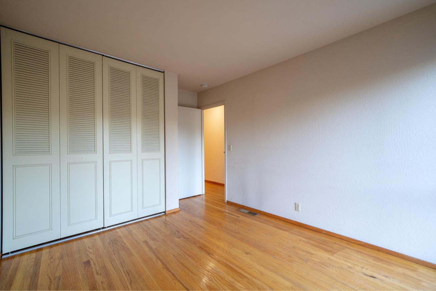 935 Park Pacifica Avenue Pacifica, CA 94044 - Photo 29 of 44 a view of an empty room with wooden floor
