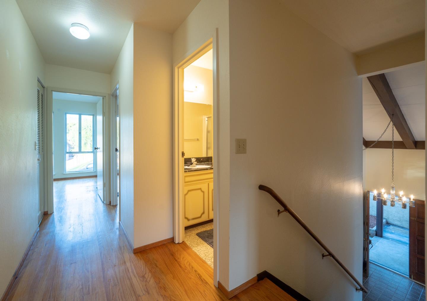 935 Park Pacifica Avenue Pacifica, CA 94044 - Photo 31 of 44 a view of a hallway with wooden floor and stairs