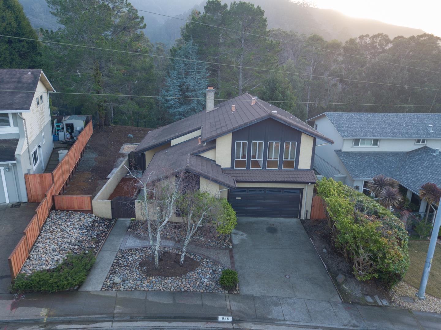 935 Park Pacifica Avenue Pacifica, CA 94044 - Photo 40 of 44 a view of a house with a yard