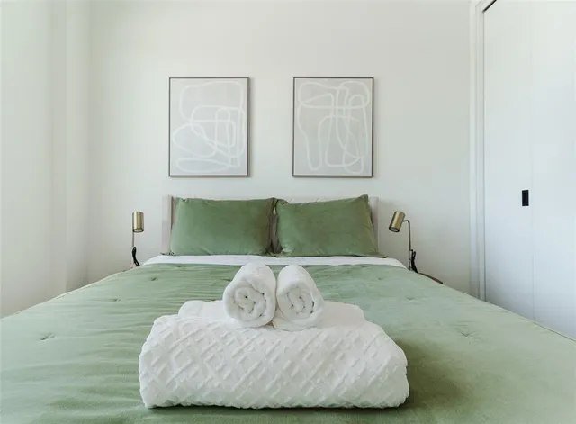 a bedroom with a bed and a couch