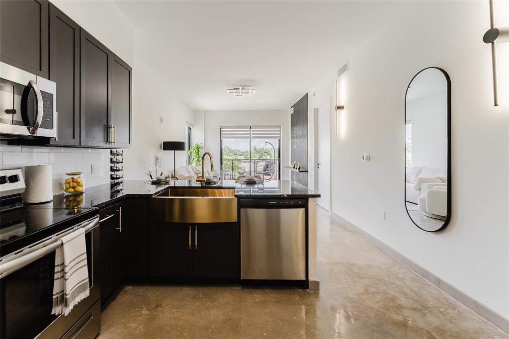 2750 Griffin Road, Unit 412 Fort Lauderdale, FL 33312 - Photo 4 of 47 a kitchen with stainless steel appliances granite countertop a stove and a refrigerator