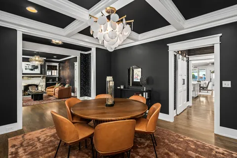 a view of a dining room and livingroom with furniture wooden floor and chandelier