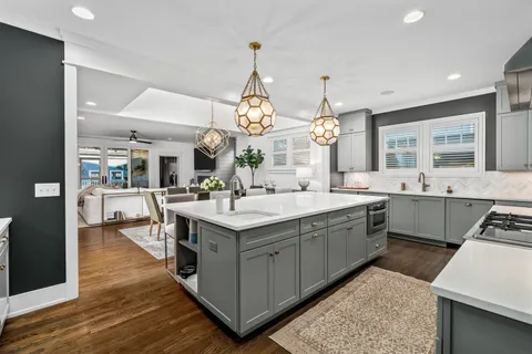 a view of a dining room with furniture wooden floor and chandelier