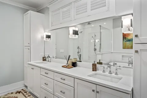 a view of a house with a yard and wooden fence