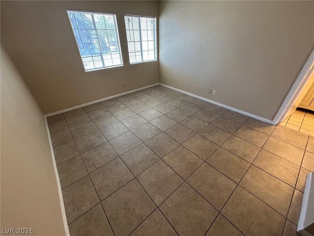 2806 Rungsted Street Las Vegas, NV 89142 - Photo 15 of 18 Well-lit room featuring durable tile flooring, ready for personalized touches.
