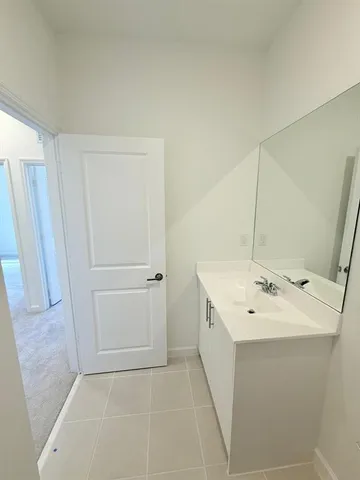 a bathroom with a toilet and a mirror