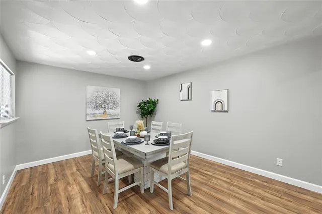 a dining room with furniture and window