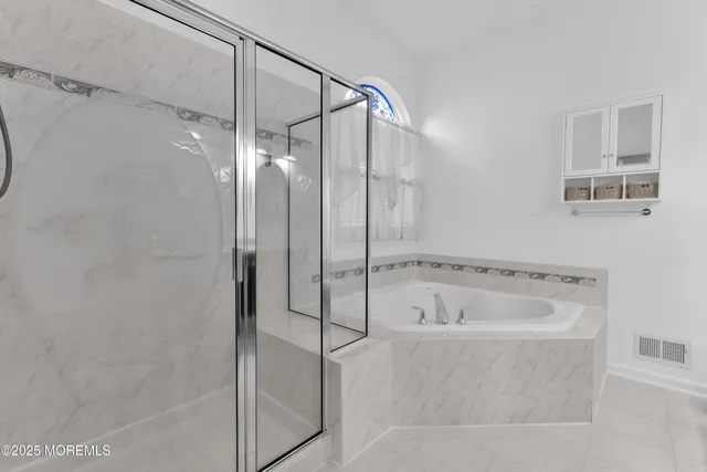a bathroom with a bathtub and a shower