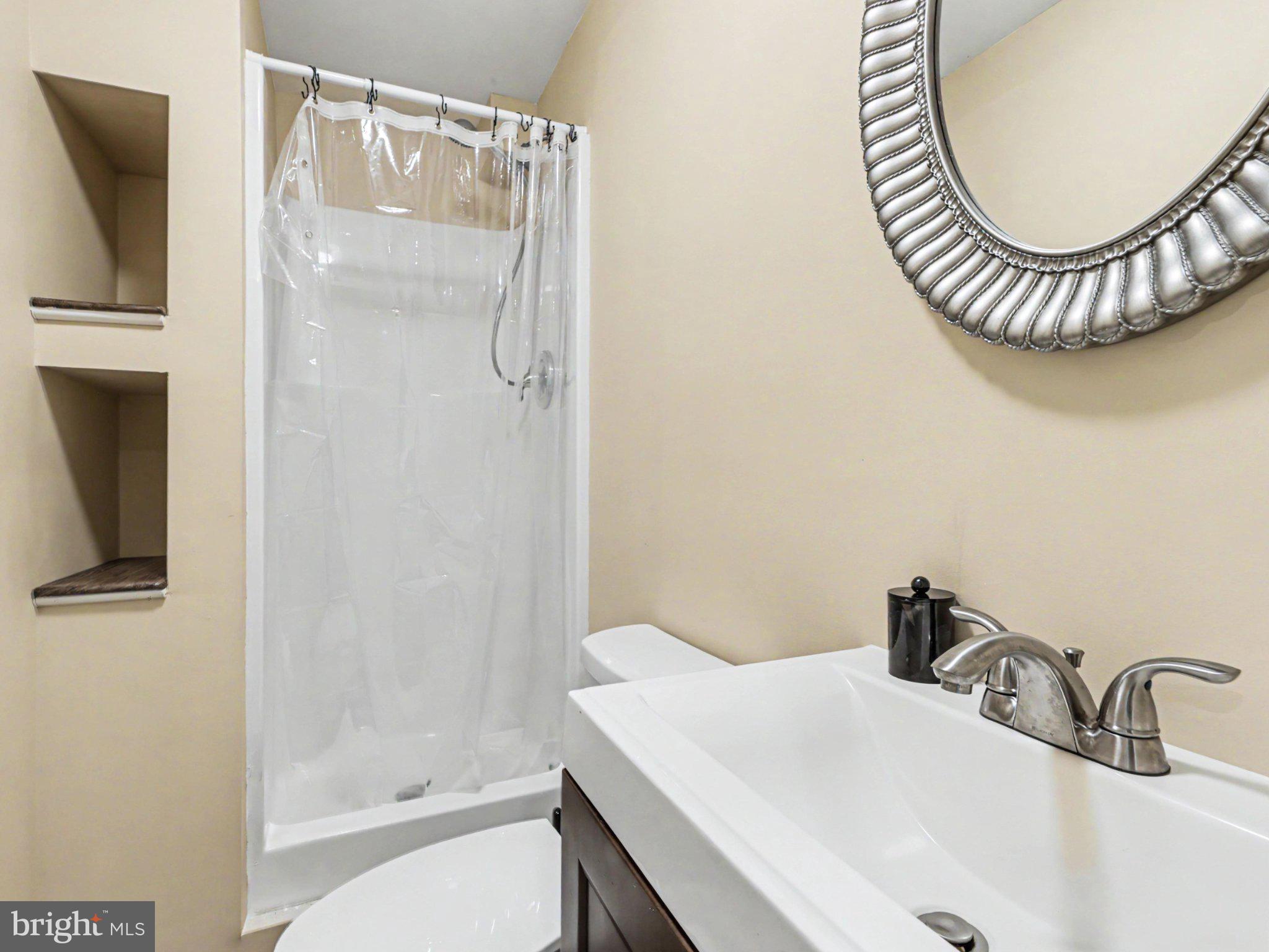 9811 Catharpin Road Spotsylvania, VA 22551 - Photo 24 of 30 a bathroom with a sink a mirror and a shower