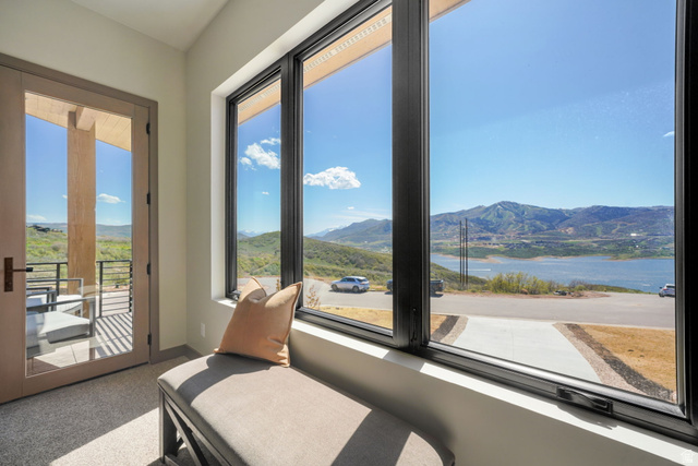 10646 North Reflection Ridge Hideout, UT 84036 - Photo 29 of 43 Expansive window wall with black frames and a large glass door opening to a private balcony