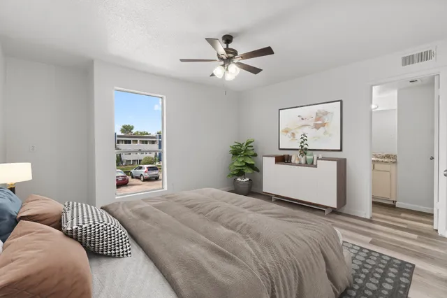 a bedroom with a large bed and a window