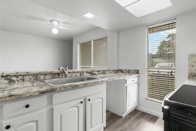 a kitchen with a stove and white cabinets