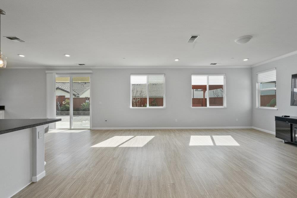 638 Summerfield Drive Soledad, CA 93960 - Photo 13 of 50 an empty room with wooden floor and windows