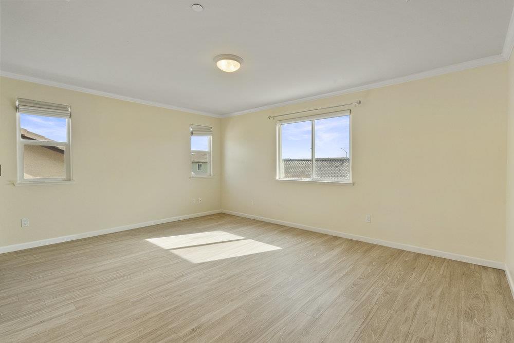638 Summerfield Drive Soledad, CA 93960 - Photo 29 of 50 an empty room with wooden floor and windows