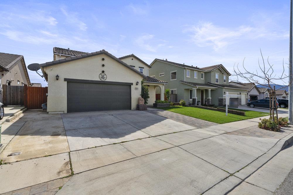 638 Summerfield Drive Soledad, CA 93960 - Photo 4 of 50 a view of a white house with a small yard and a large tree